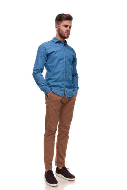 istock serious casual man standing looks to side 992033448