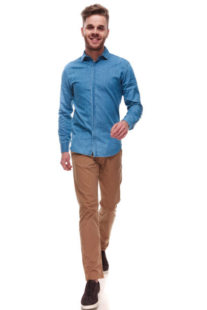 istock happy casual man with blue shirt walking forward 992034238