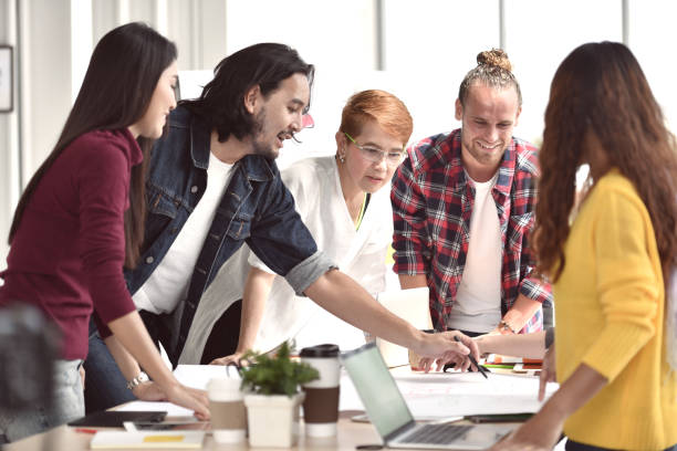 istock Group of young businesspersons having discussion and sharing opinions 992034340