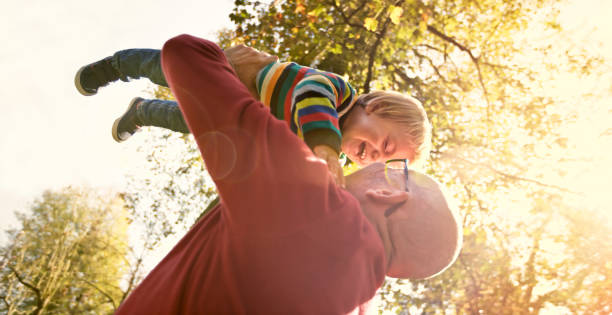 istock Father and son playing in park 992034582