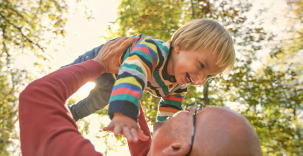 istock Father and son playing in park 992034584