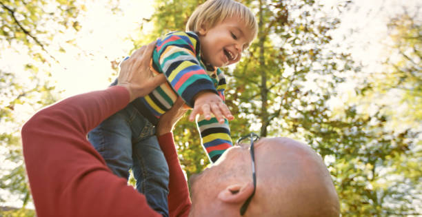 istock Father and son playing in park 992034586