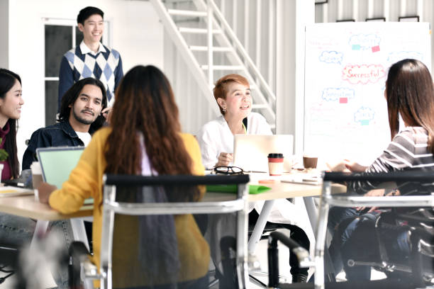 istock Group of businesspersons casually discussing work and chatting 992034900