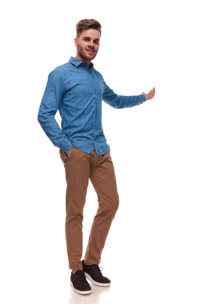 istock relaxed casual man standing and presenting behind 992041578