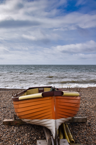 A rowing boat rests on a stand on Brighton Beach