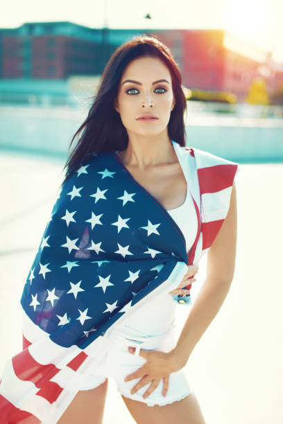 istock Seunsual young woman posing in american flag outdoors sunset 992042764