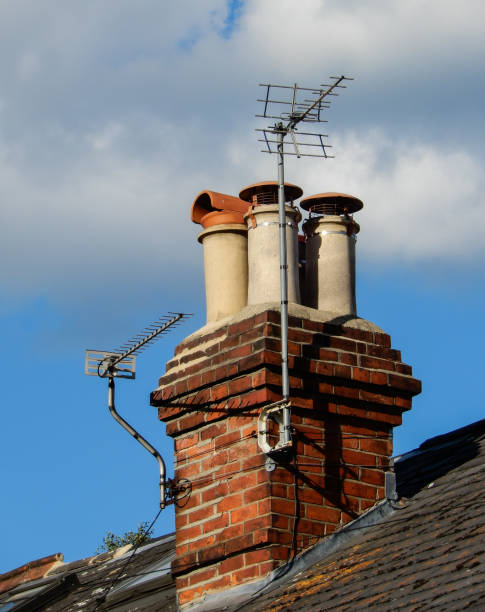 istock A Pair of Television aerials attached to a stack of four chimneys 992042820