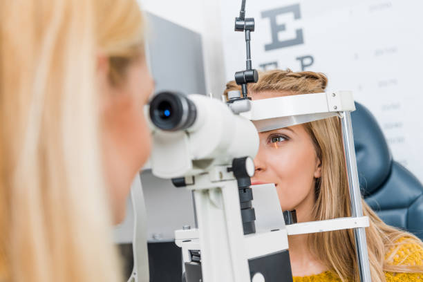 istock optometrist examining patient through slit lamp in clinic 992043384