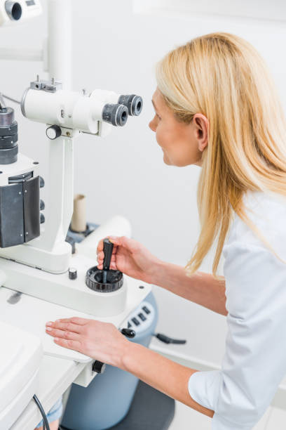 istock professional optician working with slit lamp in clinic 992046252