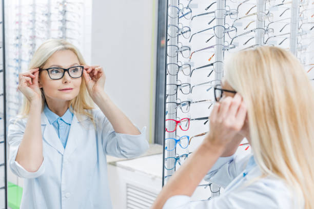 istock attractive female ophthalmologist wearing glasses while standing in optics 992047234