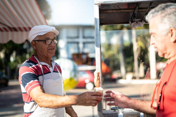 istock Mature Man selling churros at street 992048552