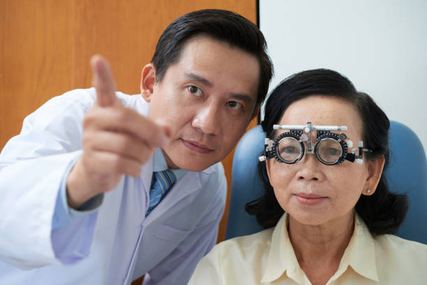istock Asian oculist working with mature woman 992052102