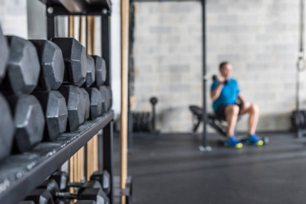 istock Mid adult man weight training in gym 992052316