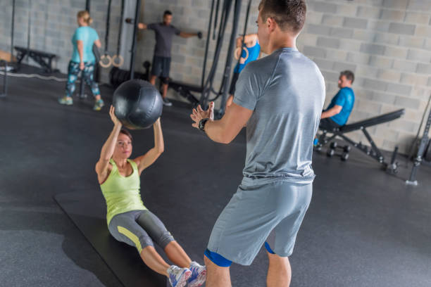 istock Young woman practicing with medicine ball 992052320