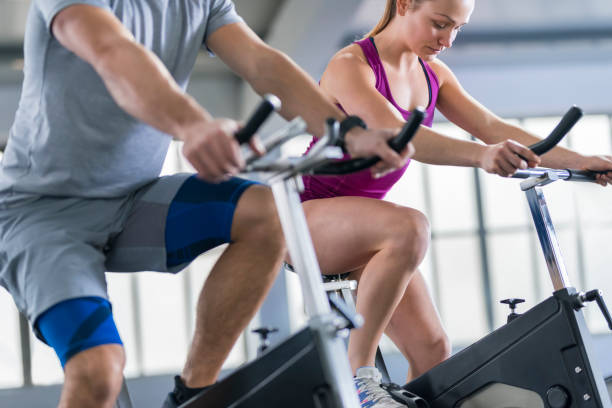 istock Young woman and instructor exercising in gym 992052356