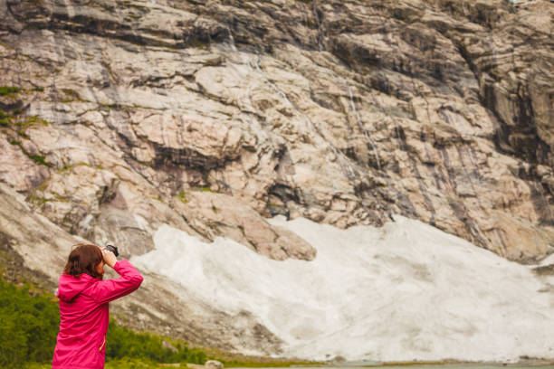 istock Tourist photographer with camera in mountains Norway 992052396