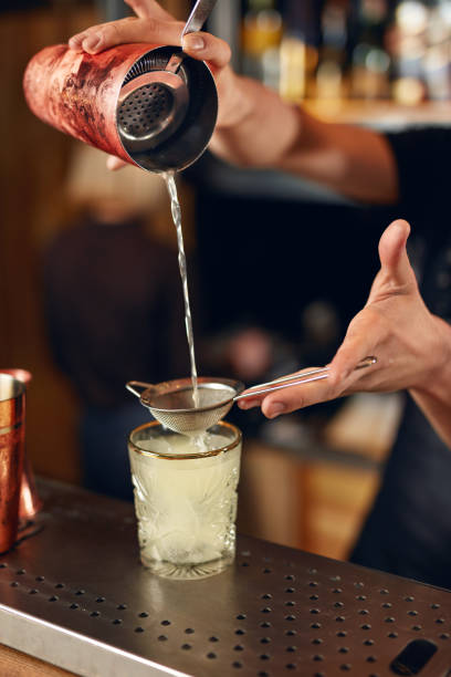 istock Cocktail Bar. Bartender Making Cocktails, Pouring Drink In Glass 992055538