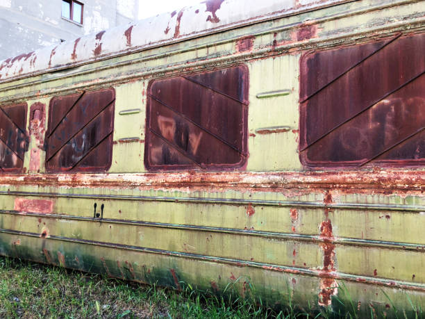 istock Abandoned train. Forgotten overgrown railway. Old rusty railway carriage 992055686