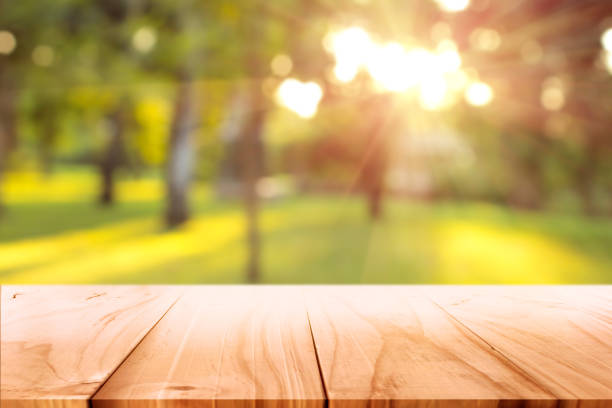 istock empty wooden on blurred nature backdrop. Wood table top. can used for display or montage your products 992070864