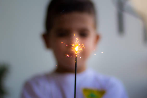Little boy with a sparkler in his hands. Focus in the bengal Little boy with a sparkler in his hands. Focus in the bengal puerto rico photos stock pictures, royalty-free photos & images