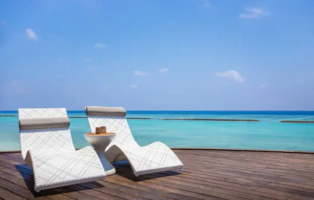 Deckchair and beautiful turquoise Indian ocean in Maldives