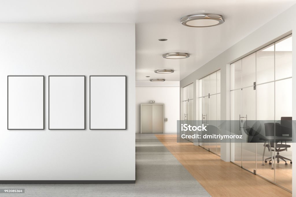 Blank poster on the wall in modern office Blank three vertical poster on the wall in modern office with clipping path around poster. 3d illustration Office Stock Photo