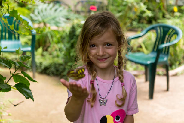 istock Smiling Blond Girl With Yellow Spotted Butterfly 992089228