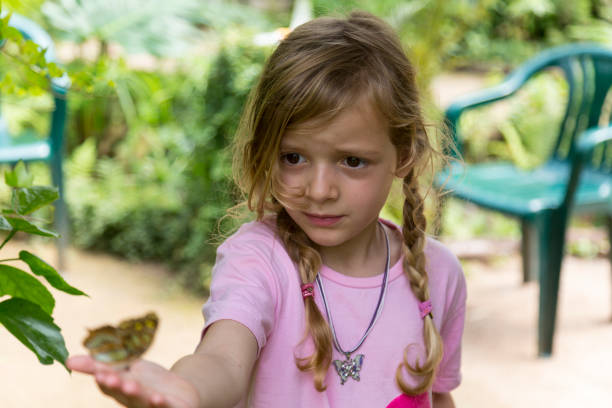 istock Blond Girl With Yellow Spotted Butterfly 992089234