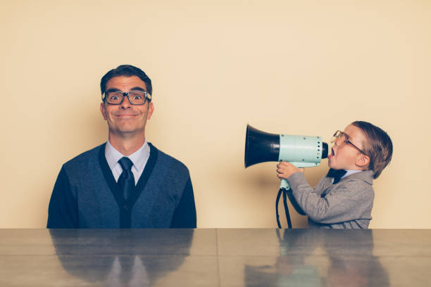 istock Young Nerd Boy Yelling at Dad with Megaphone 992091506