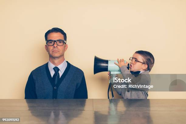 Young Nerd Boy Yelling At Dad Through Megaphone Stock Photo - Download Image Now - Confusion, Humor, Noise