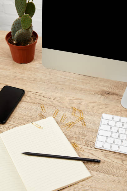 istock close up view of designer workspace with smartphone, notebook, computer screen and keyboard on wooden surface 992091736