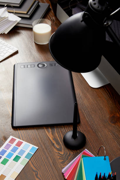 istock close up view of graphic designer workplace with colorful pallet, graphic tablet and computer screen on wooden surface 992091812