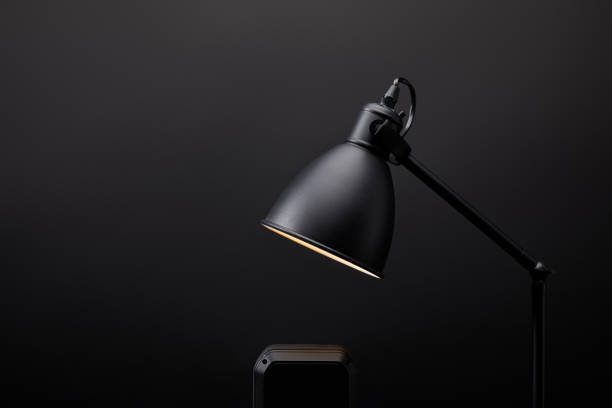 istock close up view of black audio speaker and lamp on black wall backdrop 992094496