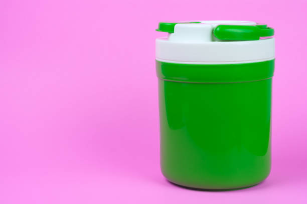 istock Green Bottle for Cold Water on pink Background. 992094702