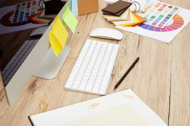 istock close up view of designer workplace with computer screen with colorful stickers, notebooks and pallet on wooden tabletop 992095764