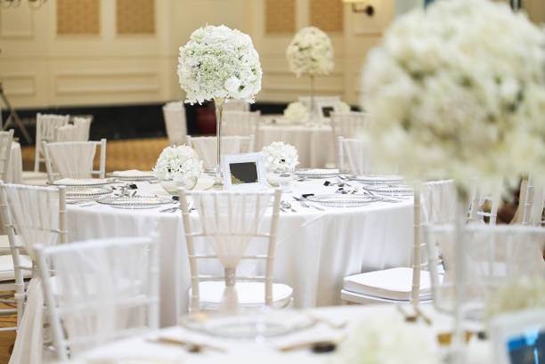 istock White roses, flower, floral decoration on the wedding reception dinner table 992096920