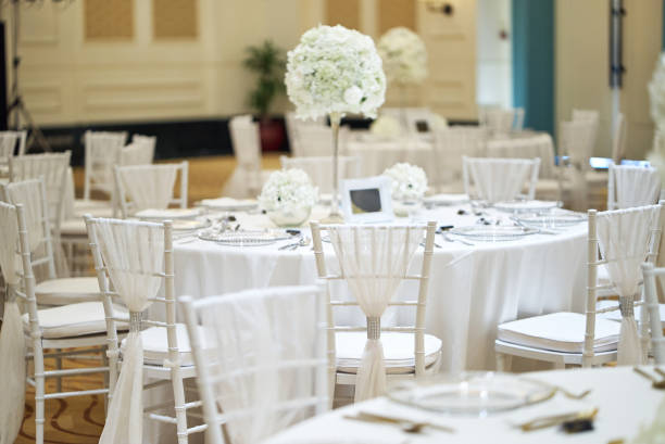 istock White roses, flower, floral decoration on the wedding reception dinner table 992097390