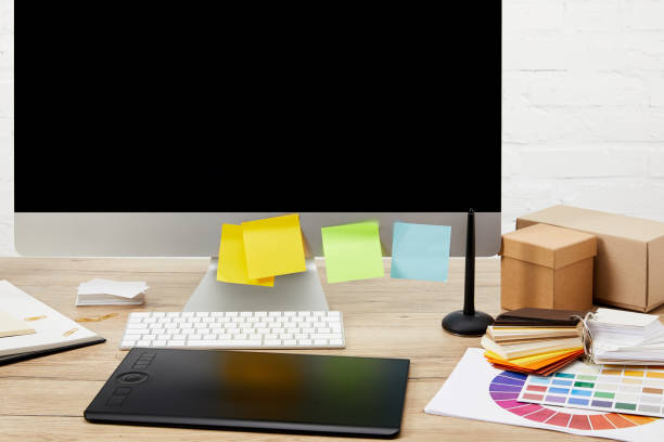 istock close up view of graphic designer workplace with computer screen with colorful stickers, graphic tablet and pallet on wooden tabletop 992097504