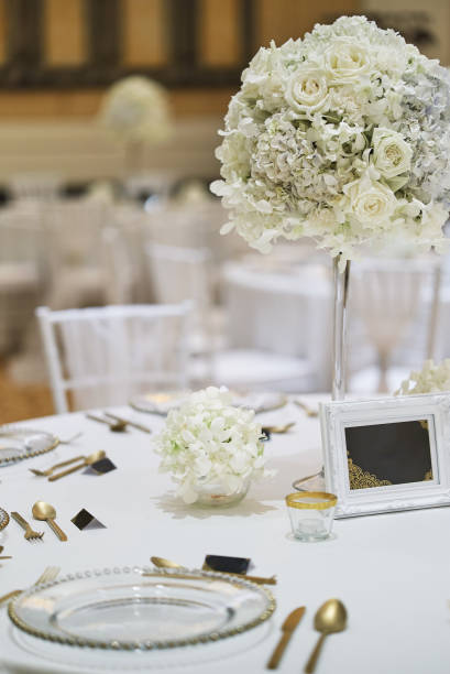 istock White roses, flower, floral decoration on the wedding reception dinner table 992097630