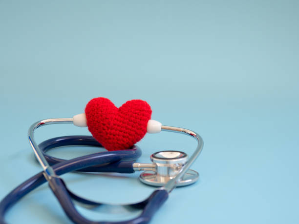 istock red heart using deep blue stethoscope on the blue background. Concept of love and caring patient by the heart. Copy space for the text and contents 992101224