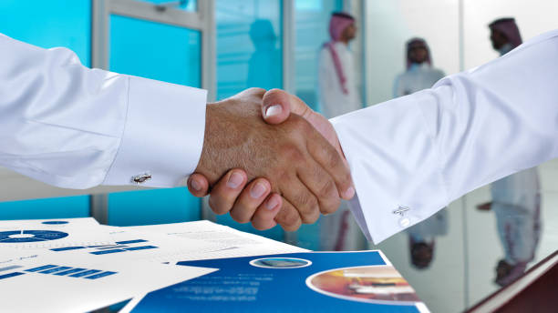 Saudi Arab businessmen shaking hands stock photo