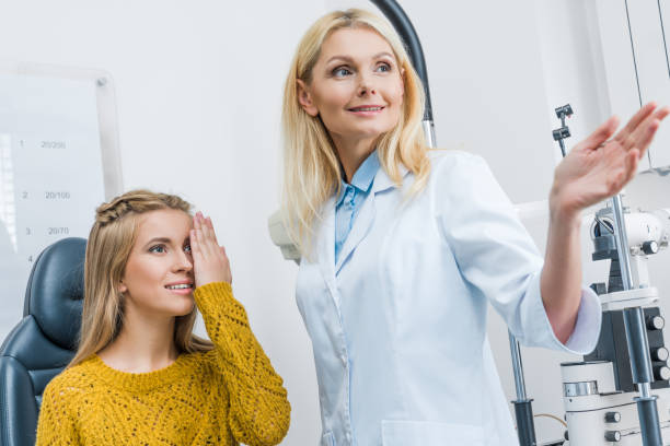 istock oculist gesturing while examining beautiful patient in clinic 992101758