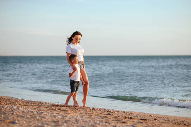 istock Young mother with son in white T-shirts 992102318