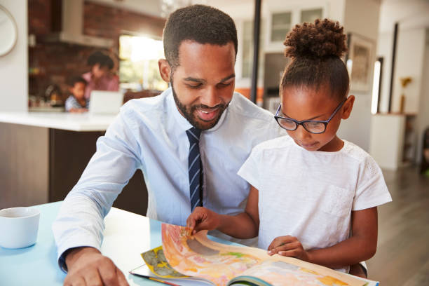 Father Reading Book With Daughter Before Going To Work Father Reading Book With Daughter Before Going To Work reading glasses stock pictures, royalty-free photos & images