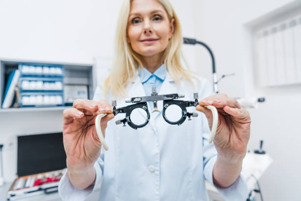 istock optometrist in white coat holding trial frame in clinic 992107580