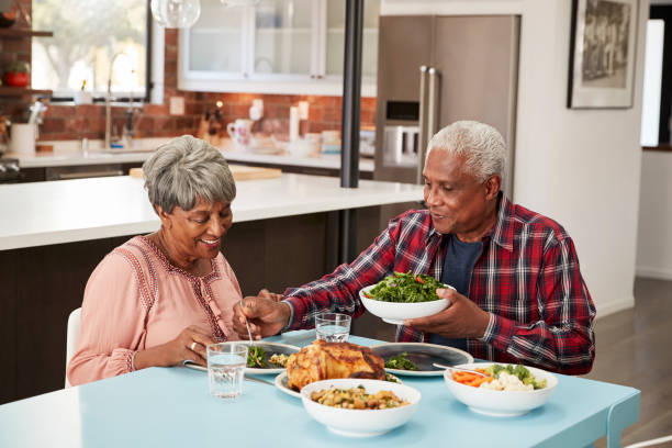 istock Senior Couple Enjoying Meal Around Table At Home 992108070