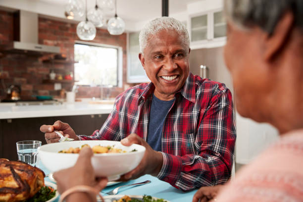 istock Senior Couple Enjoying Meal Around Table At Home 992108086