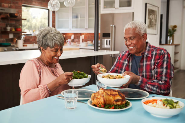 istock Senior Couple Enjoying Meal Around Table At Home 992108092