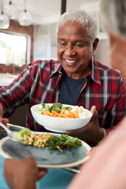 istock Senior Couple Enjoying Meal Around Table At Home 992108178