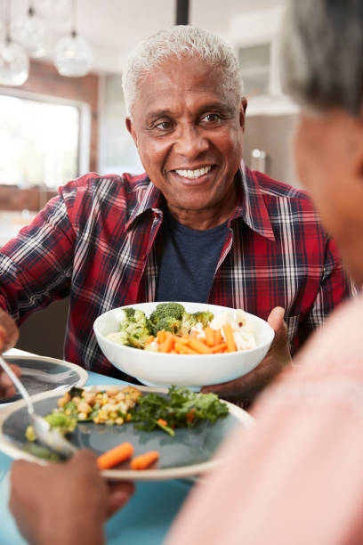 istock Senior Couple Enjoying Meal Around Table At Home 992108248